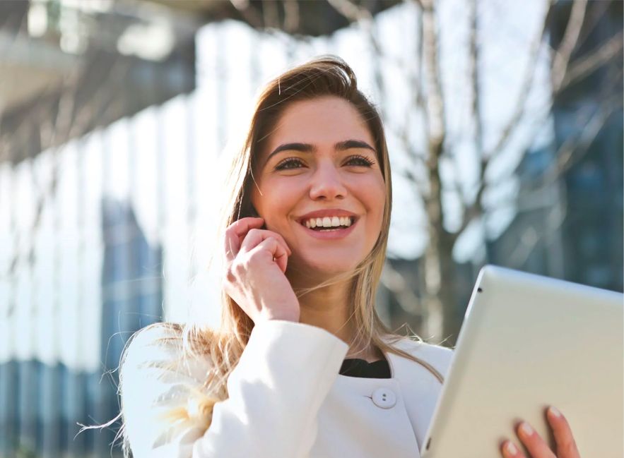 Woman on Mobile Phone Holding Tablet